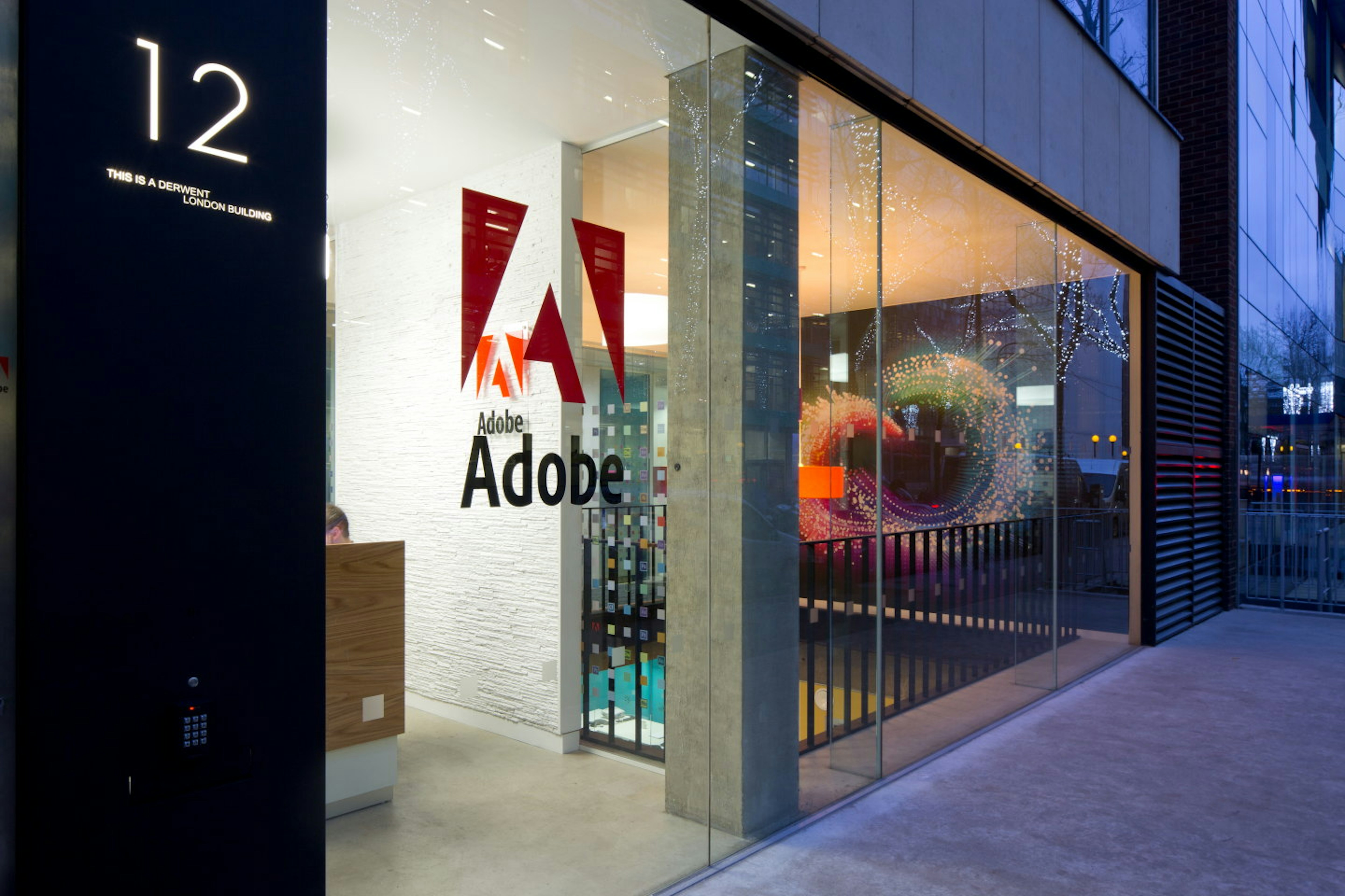 Glass facade revealing a stylish and creative workspace - Adobe