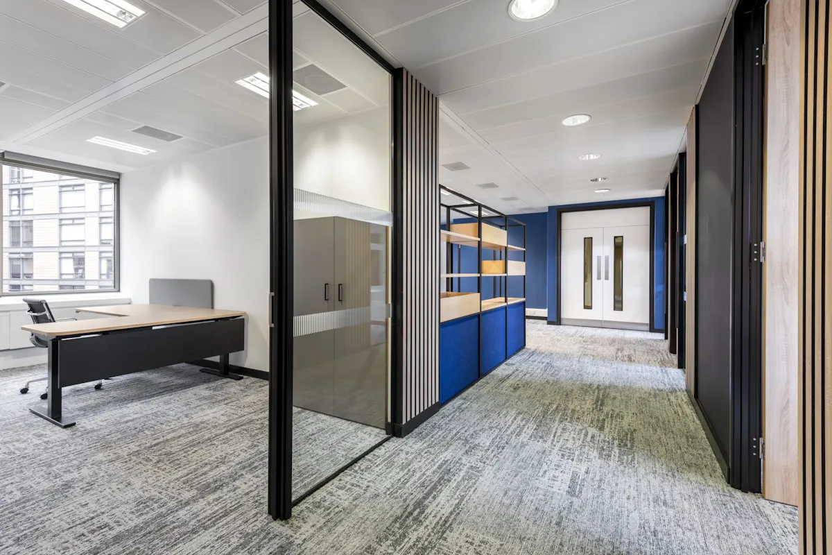 Wayfinding and Circulation — IMSO, London by K2 Space Generous office corridor with glass partitions designed for clear wayfinding and natural circulation at IMSO London by K2 Space