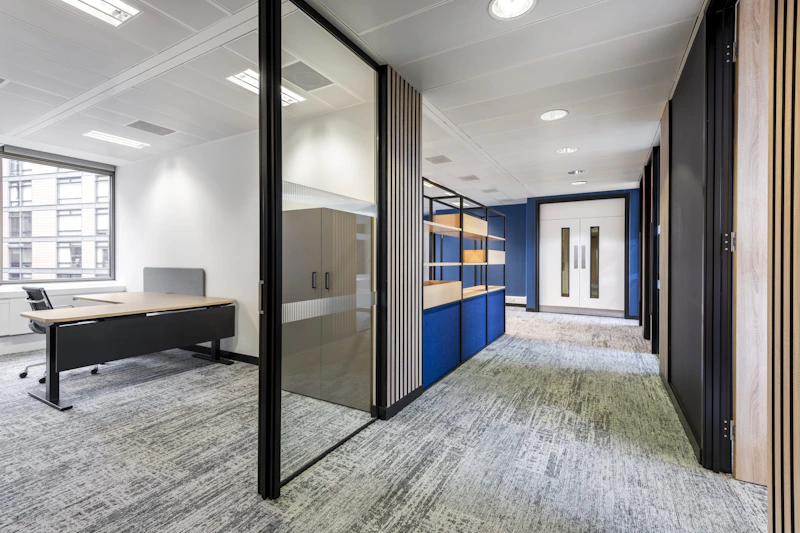 Glass partitions allowing light to penetrate deep into the floor at IMSO by K2 Space