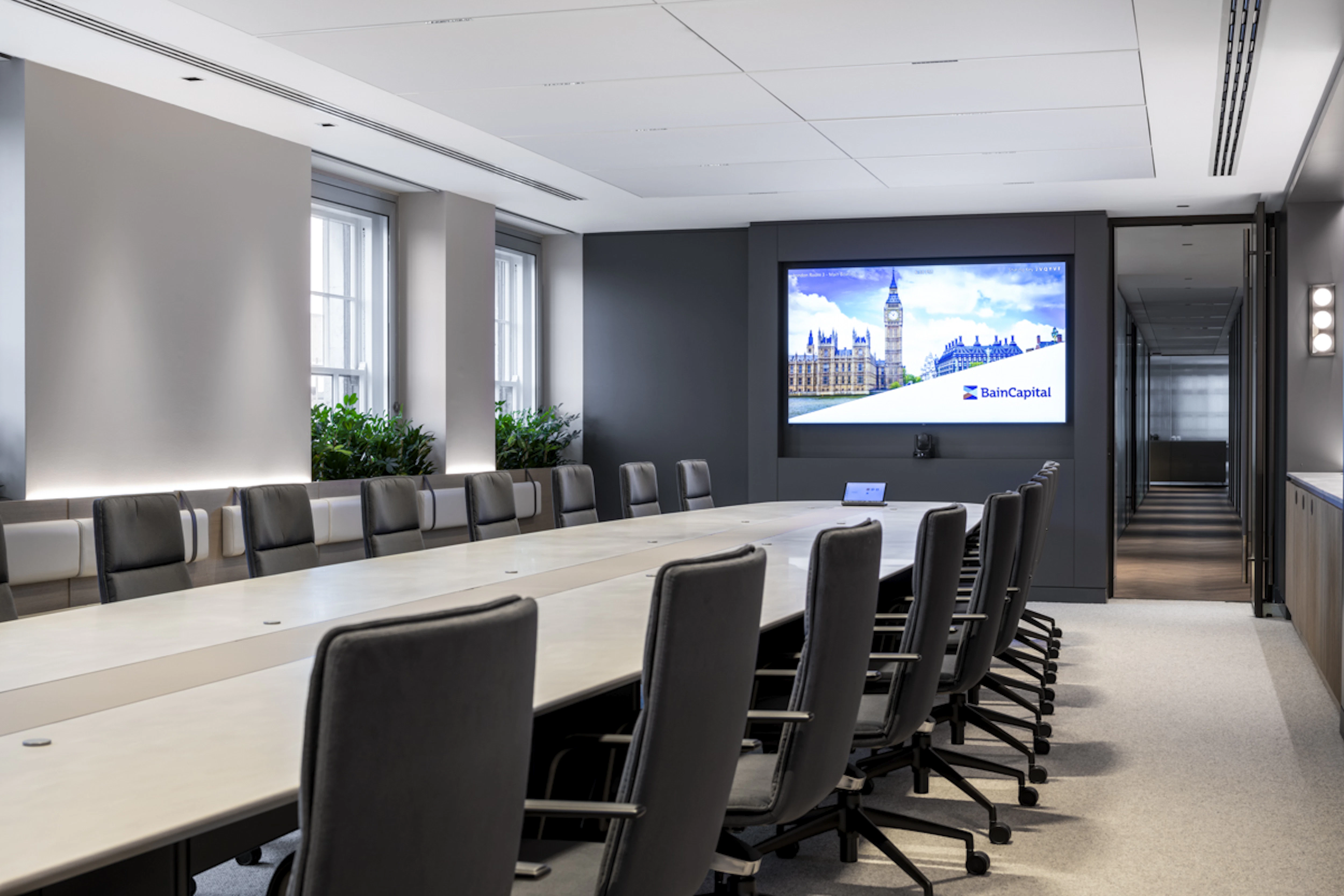 Global Private Investment Firm - Bain Capital logo displayed on a large screen in the boardroom - SMALL-6