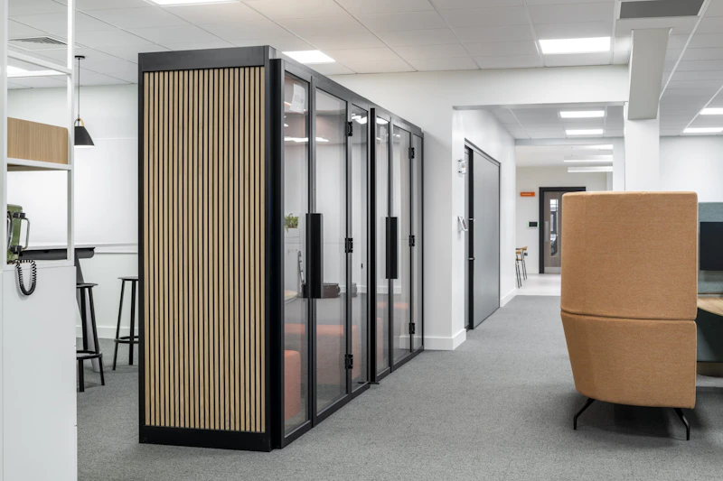 Soundproof Phone Booths — OSRL, Southampton by K2 Space Wood-slatted soundproof phone booths integrated into the open plan workspace at OSRL Southampton by K2 Space