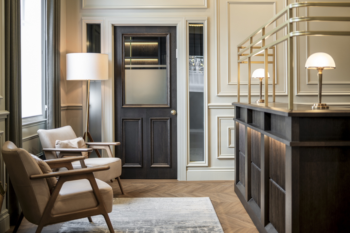 Panelled period interior with lounge seating in a London investment office