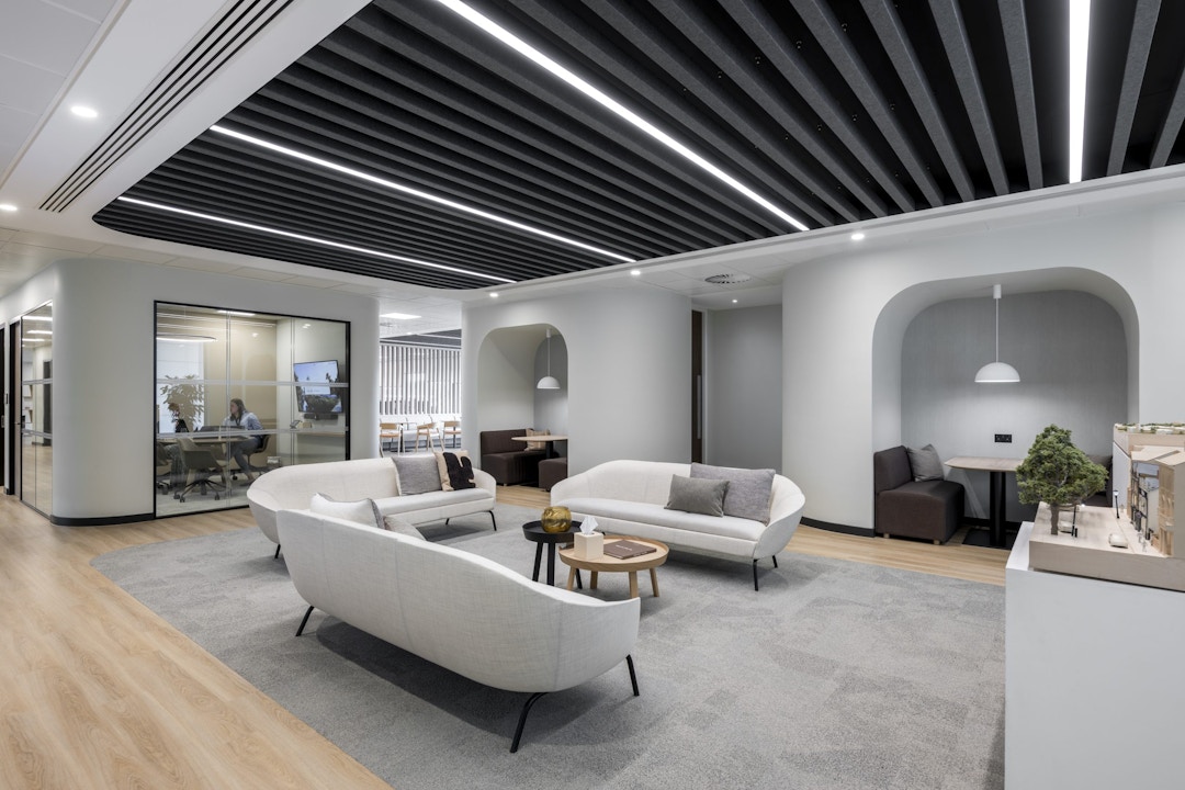 Statement Ceiling Defining Collaboration Zone Feature ceiling with integrated lighting shaping a collaborative workspace