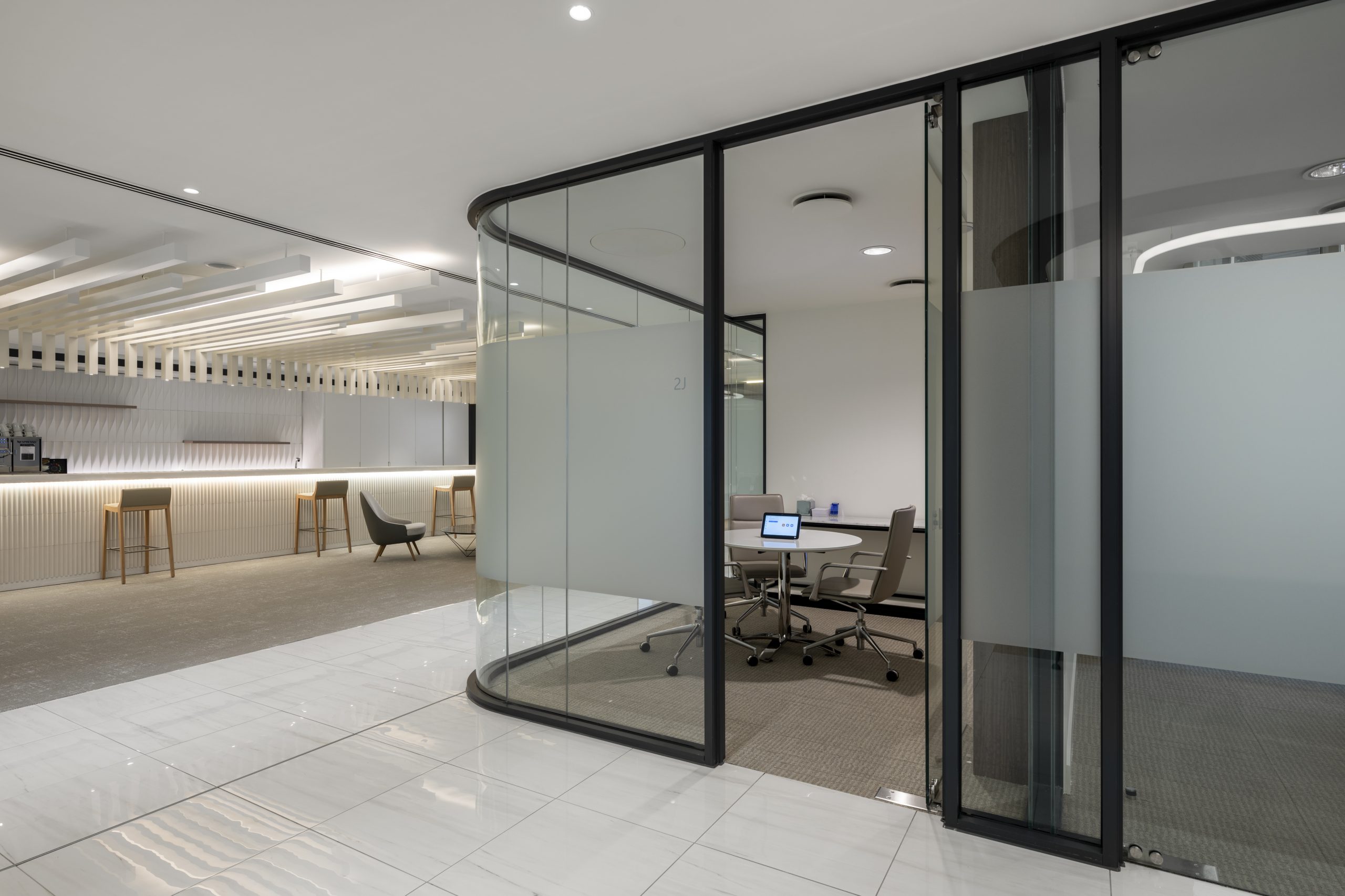 Curved glass meeting rooms with feature lighting in a London office