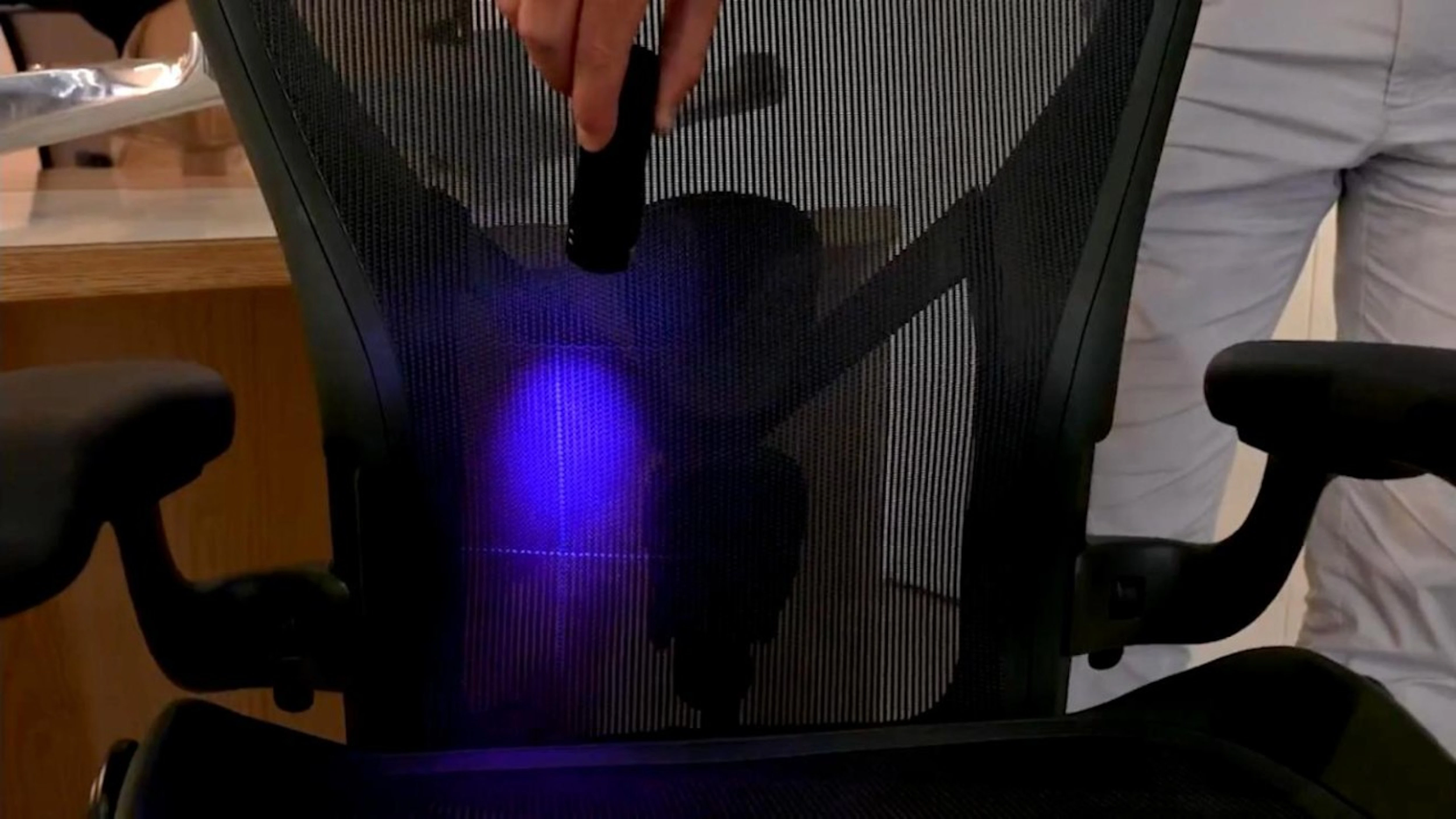 UV torch showing the 8Z Pellicle tension zones in the Herman Miller Aeron chair mesh